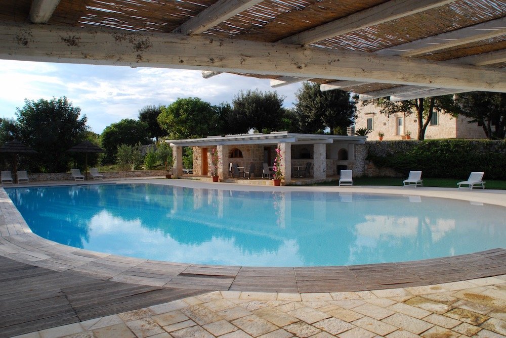 Zwembad van Masseria Cappuccini in Ostuni, Puglia – kleinschalige accommodatie met trulli, omgeven door olijfgaarden en een idyllisch landschap